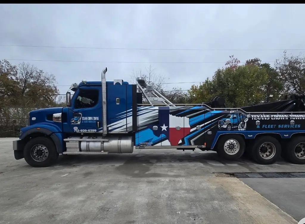 Side view of a heavy-duty wrecker on a concrete pad